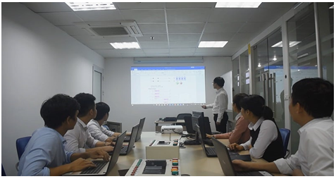 A group of people in a roomDescription automatically generated with low confidence